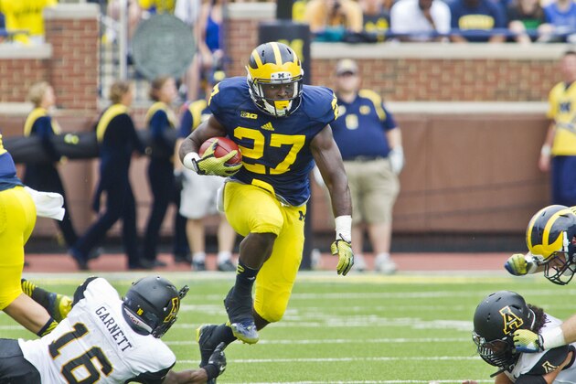 Appalachian State defensive back Treyon Garnett (16) fails to stop Michigan running back Derrick Green (27) in the third quarter of an NCAA college football game in Ann Arbor, Mich., Saturday, Aug. 30, 2014. Michigan won 52-14. (AP Photo/Tony Ding)