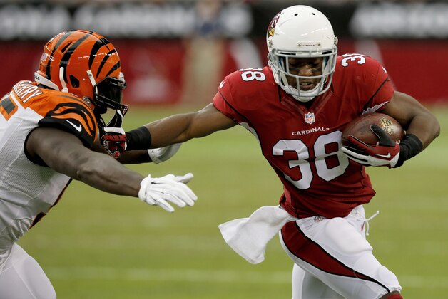 Arizona Cardinals running back Andre Ellington (38) stiff arms Cincinnati Bengals defensive end Wallace Gilberry during the first half of an NFL preseason football game, Sunday, Aug. 24, 2014, in Glendale, Ariz. (AP Photo/Ross D. Franklin)