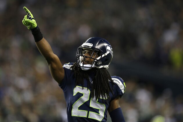 Seattle Seahawks cornerback Richard Sherman points to the crowd in the second half of an NFL football game between the Seattle Seahawks and the Green Bay Packers, Thursday, Sept. 4, 2014, in Seattle. (AP Photo/Scott Eklund)