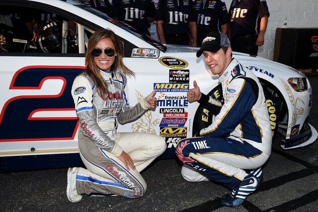 RICHMOND, VA - SEPTEMBER 05:  Brad Keselowski, driver of the #2 Miller Lite Ford, right, and Miss Coors Light Rachel Rupert pose with the Coors Light Pole Award sticker after Keselowski qualified for the pole for the NASCAR Sprint Cup Series Federated Auto Parts 400 at Richmond International Raceway on September 5, 2014 in Richmond, Virginia.  (Photo by Patrick Smith/Getty Images)