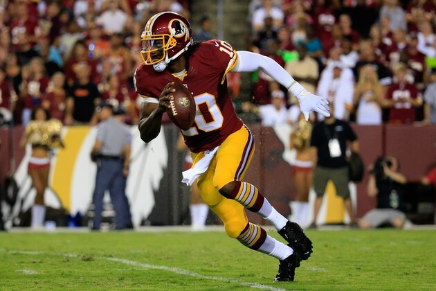 LANDOVER, MD - AUGUST 18: Quarterback Robert Griffin III #10 of the Washington Redskins rolls out during a preseason game against the Cleveland Browns at FedExField on August 18, 2014 in Landover, Maryland.  (Photo by Rob Carr/Getty Images)