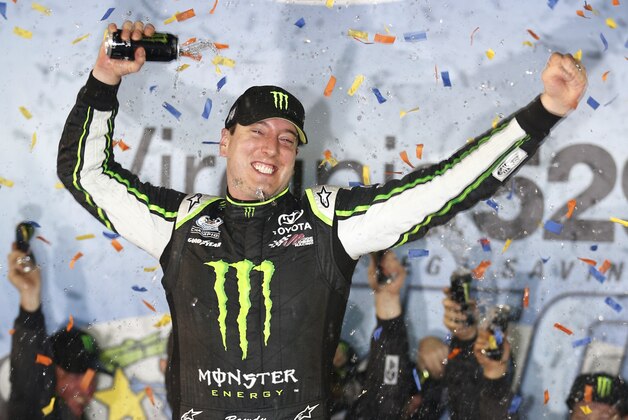 Kyle Busch celebrates his win in the NASCAR Nationwide series auto race, in Victory Lane at Richmond International Raceway in Richmond, Va., Friday, Sept. 5, 2014. (AP Photo/Steve Helber)