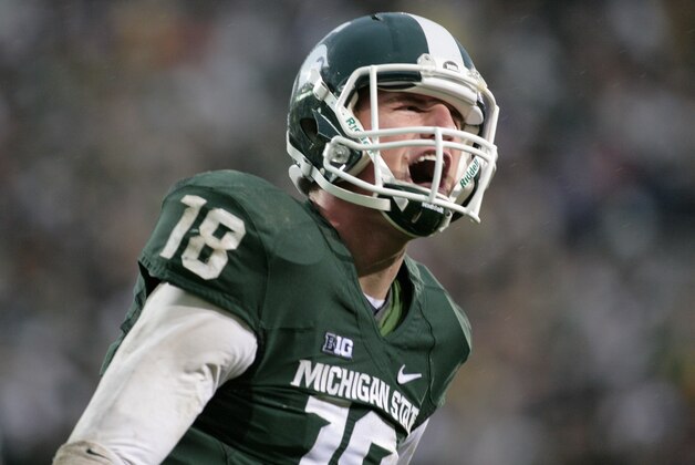 FILE - In this Nov. 2, 2013, file photo,  Michigan State quarterback Connor Cook yells in celebration after scoring a touchdown against Michigan during an NCAA college football game, in East Lansing, Mich. Cook finished the 2013 season strong, throwing for 304 yards and three touchdowns against Ohio State in the Big Ten championship game and for a career-high 332 yards and two TDs against Stanford while being named Offensive MVP of the Rose Bowl. (AP Photo/Al Goldis)