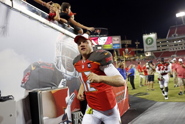 Tampa Bay Buccaneers quarterback Josh McCown (12) runs through the tunnel following an NFL preseason football game against the Washington Redskins on Thursday, Aug. 28, 2014, in Tampa, Fla. (AP Photo/Brian Blanco)