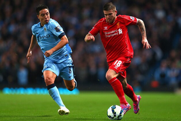 MANCHESTER, ENGLAND - AUGUST 25:   Alberto Moreno of Liverpool competes with Samir Nasri of Manchester City during the Barclays Premier League match between Manchester City and Liverpool at the Etihad Stadium on August 25, 2014 in Manchester, England.  (Photo by Clive Brunskill/Getty Images)