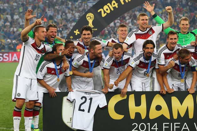 RIO DE JANEIRO, BRAZIL - JULY 13: Shkodran Mustafi of Germany holds a jersey of the injured Marco Reus as he celebrates with teammates after defeating Argentina 1-0 in extra time during the 2014 FIFA World Cup Brazil Final match between Germany and Argentina at Maracana on July 13, 2014 in Rio de Janeiro, Brazil.  (Photo by Martin Rose/Getty Images)