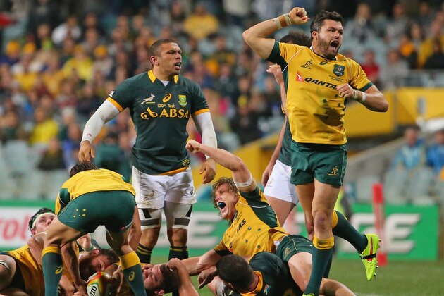PERTH, AUSTRALIA - SEPTEMBER 06:  Michael Hooper and Adam Ashley-Cooper of the Wallabies celebrate victory at the final whistle as Bryan Habana of the Springboks looks on during The Rugby Championship match between the Australian Wallabies and the South African Springboks at Patersons Stadium on September 6, 2014 in Perth, Australia.  (Photo by Scott Barbour/Getty Images)