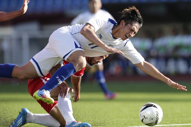 Taiwan's Li Mao (11) is fouled by Palestine's Raed M.K. Fares as they battle for third place in the Peace Cup 2014 soccer friendly match Saturday, Sept. 6, 2014 at the Rizal Memorial Football Stadium in Manila, Philippines. Palestine won 7-3 in extra time to bag the bronze. (AP Photo/Bullit Marquez)