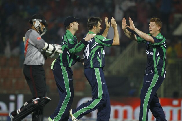 Ireland's Tim Murtagh, second right, celebrates with his teammates the wicket of United Arab Emirates's captain Khurram Khan, left, during their ICC Twenty20 Cricket World Cup match in Sylhet, Bangladesh, Wednesday, March 19, 2014. (AP Photo/A.M. Ahad)