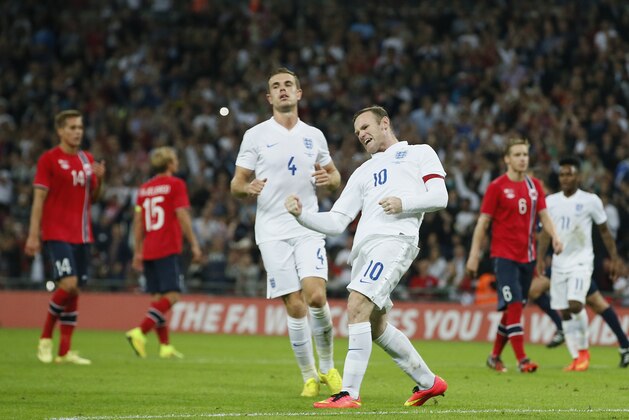 England's Wayne Rooney celebrates after scoring the opening goal during the international friendly soccer match between England and Norway at Wembley Stadium in London, Wednesday, Sept. 3, 2014. (AP Photo/Alastair Grant)
