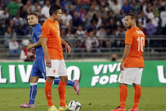 Italy's Ciro Immobile, left, celebrates past Netherlands' Robin van Persie, second from left, and Netherlands'  Wesley Sneijder after he scored during a friendly soccer match between Italy and The Netherlands in Bari, Italy, Thursday, Sept. 4, 2014. (AP Photo/Gregorio Borgia)