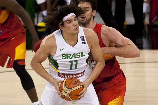 Brazil's Anderson Varejao, left, protects the ball from Spain's Pau Gasol during the Group A Basketball World Cup match between Brazil and Spain in Granada, Spain, Monday, Sept. 1, 2014. The 2014 Basketball World Cup competition will take place in various cities in Spain from Aug. 30 through to Sept. 14. (AP Photo/Daniel Tejedor)