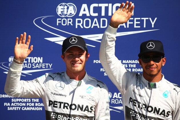 MONZA, ITALY - SEPTEMBER 06:  (L-R) The top two qualifying drivers, Nico Rosberg (2nd) of Germany and Mercedes GP and Lewis Hamilton (Pole) of Great Britain and Mercedes GP pose for the cameras following Qualifying ahead of the F1 Grand Prix of Italy at Autodromo di Monza on September 6, 2014 in Monza, Italy.  (Photo by Mark Thompson/Getty Images)