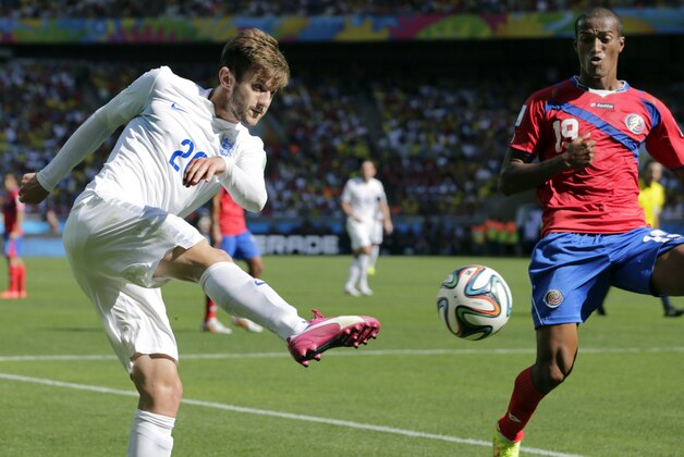 FILE - In this Tuesday, June 24, 2014 file photo, England's Adam Lallana, left,  kicks a cross as Costa Rica's Roy Miller defends during the group D World Cup soccer match between Costa Rica and England at the Mineirao Stadium in Belo Horizonte, Brazil. Liverpool completed the signing of England midfielder Adam Lallana from Southampton on Tuesday, July 1, 2014. Lallana, who is believed to have signed a five-year deal, underwent a medical at Liverpool's training ground on Friday after Southampton accepted a reported £25 million ($43 million) bid. (AP Photo/Fernando Vergara, File)