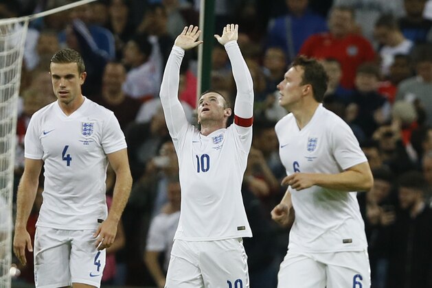 England's Wayne Rooney, center, celebrates scoring a goal during the international friendly soccer match between England and Norway at Wembley Stadium in London, Wednesday, Sept. 3, 2014. (AP Photo/Kirsty Wigglesworth)