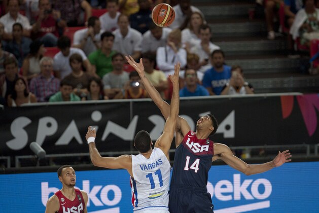 United States's Anthony Davis, right, jumps for the ball with Dominican Republic's Eloy Vargas during the Group C Basketball World Cup match in Bilbao, northern Spain, Wednesday Sept. 3, 2014. The 2014 Basketball World Cup competition take place in various cities in Spain from  Aug. 30 to Sept. 14. (AP Photo/Alvaro Barrientos)