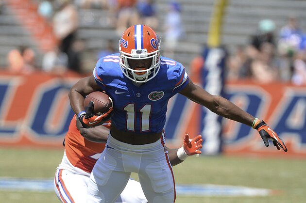 Florida wide receiver Demarcus Robinson (11) tries to get traction but is stopped by Duke Dawson (7) during the second half of Florida's Orange & Blue game Saturday, April 12, 2014 in Gainesville, Fla. The Orange & Blue game ended in a 23-23 tie. (AP Photo/Phil Sandlin)