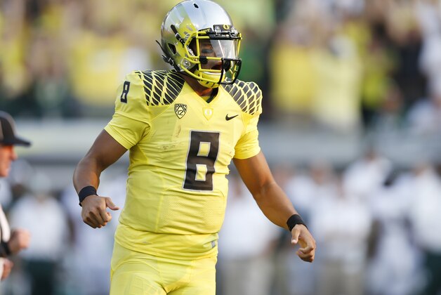 EUGENE, OR - SEPTEMBER 6: Marcus Mariota #8 of the Oregon Ducks celebrates after Royce Freeman rushed for a touchdown in the fourth quarter of the game against the Michigan State Spartans at Autzen Stadium on September 6, 2014 in Eugene, Oregon. Oregon won 46-27. (Photo by Joe Robbins/Getty Images)