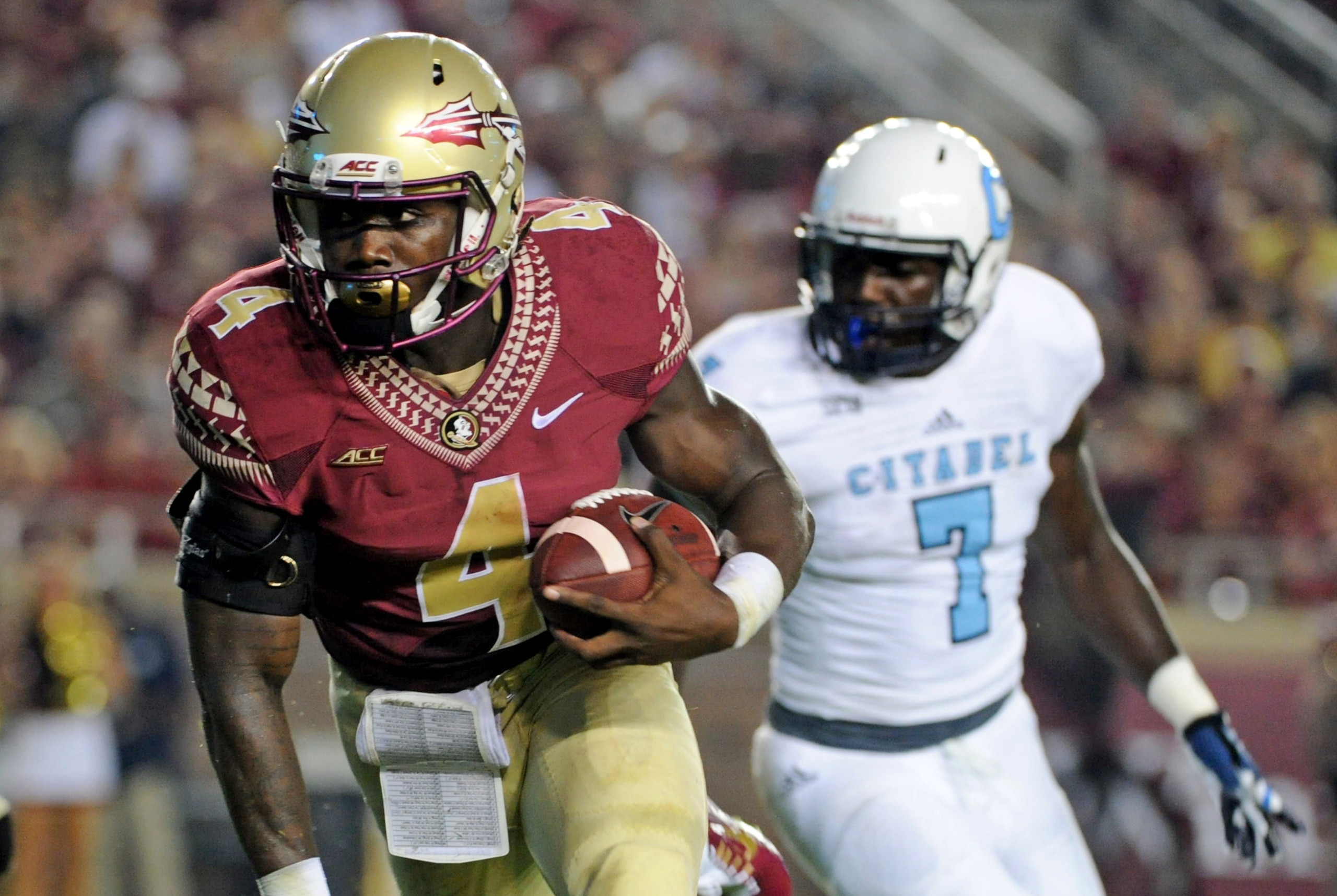 Sep 6, 2014; Tallahassee, FL, USA; Florida State Seminoles running back Dalvin Cook (4) runs the ball for a touchdon as he is pressured by Citadel Bulldogs defensive lineman Mark Thomas (7) during the first half at Doak Campbell Stadium. Mandatory Credit: Melina Vastola-USA TODAY Sports