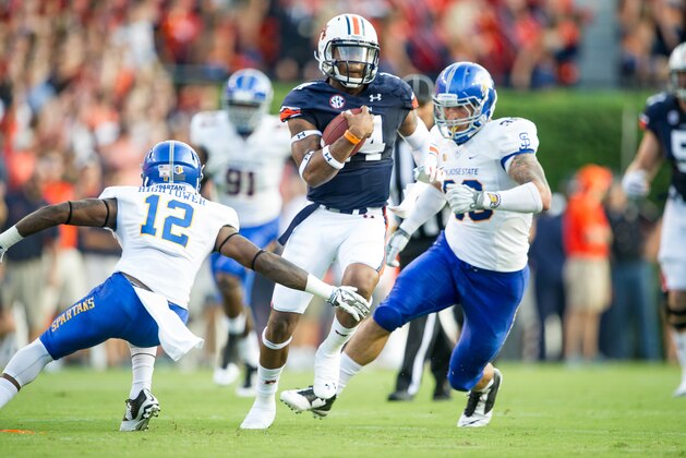 AUBURN, AL - SEPTEMBER 6: Quarterback Nick Marshall #14 of the Auburn Tigers looks to maneuver past safety Forrest Hightower #12 and linebacker Vince Buhagiar #36 of the San Jose State Spartans on September 6, 2014 at Jordan-Hare Stadium in Auburn, Alabama. At halftime Auburn leads San Jose State 38-10. (Photo by Michael Chang/Getty Images) AUBURN, AL - SEPTEMBER 6: Quarterback Nick Marshall #14 of the Auburn Tigers looks to maneuver past safety Forrest Hightower #12 and linebacker Vince Buhagiar #36 of the San Jose State Spartans on September 6, 2014 at Jordan-Hare Stadium in Auburn, Alabama. At halftime Auburn leads San Jose State 38-10. (Photo by Michael Chang/Getty Images)