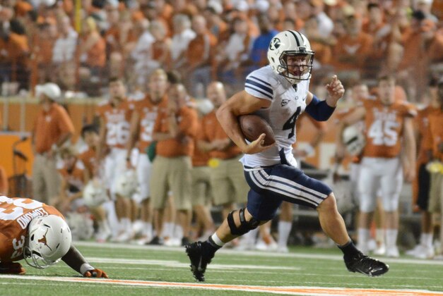 Sep 6, 2014; Austin, TX, USA; Brigham Young Cougars quarterback Taysom Hill (4) runs the ball against the Texas Longhorns during the second half at Darrell K Royal-Texas Memorial Stadium. BYU beat Texas 41-7. Mandatory Credit: Brendan Maloney-USA TODAY Sports