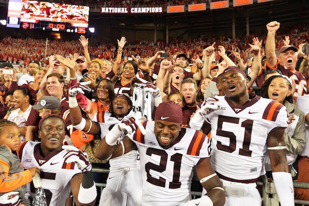COLUMBUS, OH - SEPTEMBER 6:  C.J. Reavis #21 and Melvin Keihn #51 of the Virginia Tech Hokies celebrate with fans after the Hokies upset the Ohio State Buckeyes 35-21 at Ohio Stadium on September 6, 2014 in Columbus, Ohio.  (Photo by Jamie Sabau/Getty Images)