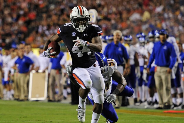 Sep 6, 2014; Auburn, AL, USA; Auburn Tigers running back Cameron Artis-Payne (44) runs a touchdown a while defended by San Jose State Spartans defensive tackle Adrian Blake (91) during the second quarter  at Jordan Hare Stadium. Mandatory Credit: Shanna Lockwood-USA TODAY Sports