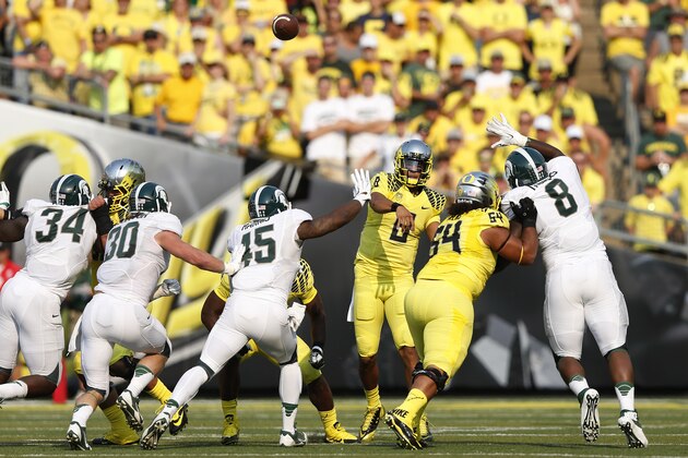 EUGENE, OR - SEPTEMBER 6: Marcus Mariota #8 of the Oregon Ducks throws the ball while under pressure during the game against the Michigan State Spartans at Autzen Stadium on September 6, 2014 in Eugene, Oregon. Oregon won 46-27. (Photo by Joe Robbins/Getty Images)