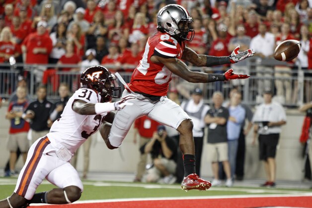 Ohio State wide receiver Corey Smith, right, drops a pass as Virginia Tech cornerback Brandon Facyson defends during the second quarter of an NCAA college football game Saturday, Sept. 6, 2014, in Columbus, Ohio. (AP Photo/Paul Vernon)