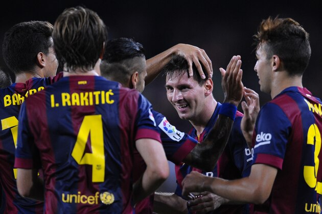 FC Barcelona's Lionel Messi from Argentina, second right, reacts after scoring against Elche during a Spanish La Liga soccer match at the Camp Nou stadium in Barcelona, Spain, Sunday, Aug. 24, 2014. (AP Photo/Manu Fernandez)