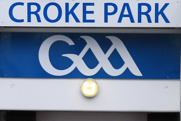 Britain's Queen Elizabeth II, centre, Irish President Mary Mc Aleese, left and  Christy Cooney, President of the Gaelic Athletic Association look out at the pitch at the home of the GAA, Croke Park Stadium, in Dublin, Wednesday May 18, 2011, site of a notorious massacre where British troops killed 14 Irish civilians in 1920.  The Queen's visit to Croke Park on the second day of her historic trip to the Republic of Ireland highlights the vast improvement in Anglo-Irish relations since those dark days. It brought the English monarch to a large sports stadium that is a revered spot for Irish nationalists who mourn those who died there during the conflict with Britain.(AP Photo/Peter Morrison)