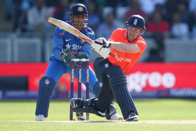 BIRMINGHAM, ENGLAND - SEPTEMBER 07: Eoin Morgan of England in action batting as MS Dohni of India looks on during the NatWest International T20 2014 match between England and India at Edgbaston on September 7, 2014 in Birmingham, England. (Photo by Clive Mason/Getty Images) BIRMINGHAM, ENGLAND - SEPTEMBER 07: Eoin Morgan of England in action batting as MS Dohni of India looks on during the NatWest International T20 2014 match between England and India at Edgbaston on September 7, 2014 in Birmingham, England. (Photo by Clive Mason/Getty Images)