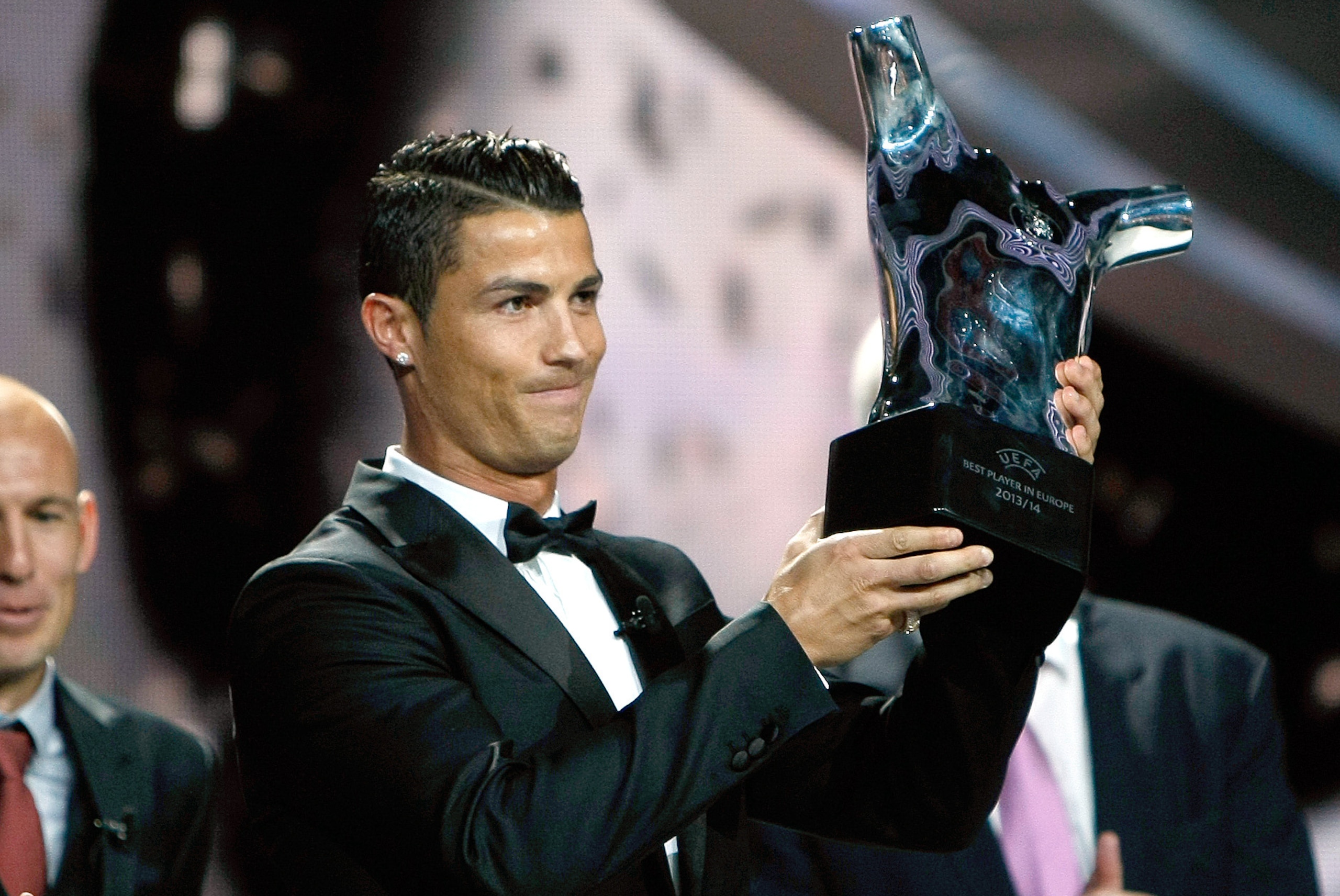 Named the best player of the year, Real Madrid Portuguese forward Cristiano Ronaldo, holds his trophy during the UEFA Champions League draw, at the Grimaldi Forum, in Monaco, Thursday, Aug. 28, 2014. (AP Photo/Claude Paris)