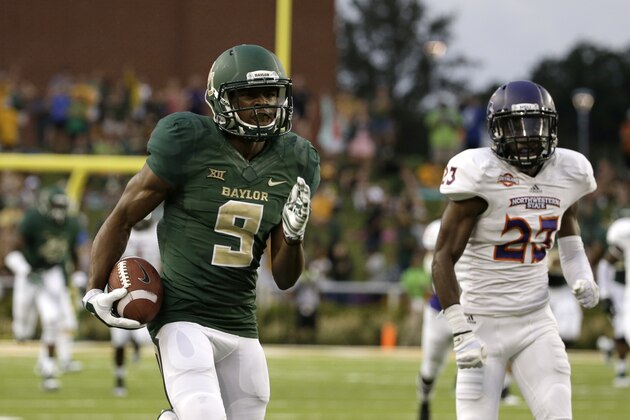 Baylor wide receiver KD Cannon (9) sprints to the end zone after a reception for a  touchdown as Northwestern State cornerback Fred Thomas (23) gives chase in the first half of an NCAA college football game, Saturday, Sept. 6, 2014, in Waco, Texas. (AP Photo/Tony Gutierrez)