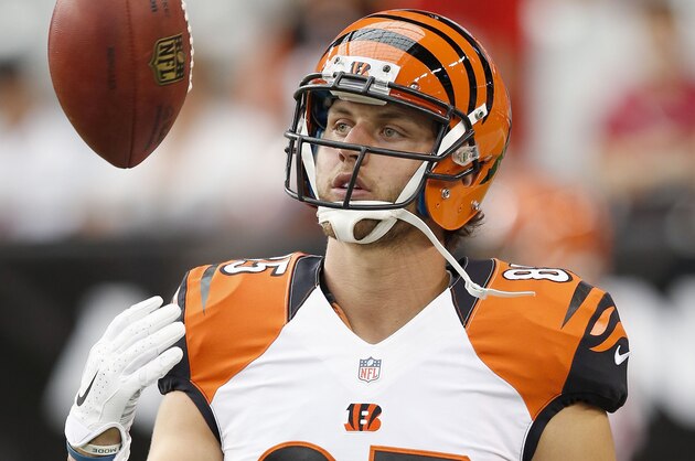 Cincinnati Bengals' Tyler Eifert flips the ball in the air as teams warm up prior to an NFL preseason football game against the Arizona Cardinals Sunday, Aug. 24, 2014, in Glendale, Ariz. (AP Photo/Ross D. Franklin)