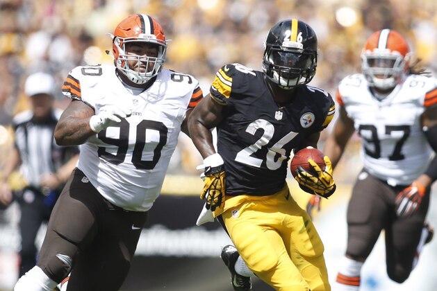 Sep 7, 2014; Pittsburgh, PA, USA; Pittsburgh Steelers running back Le'Veon Bell (26) carries the ball as Cleveland Browns defensive end Billy Winn (90) and outside linebacker Jabaal Sheard (97) chase during the first quarter against at Heinz Field. Mandatory Credit: Charles LeClaire-USA TODAY Sports