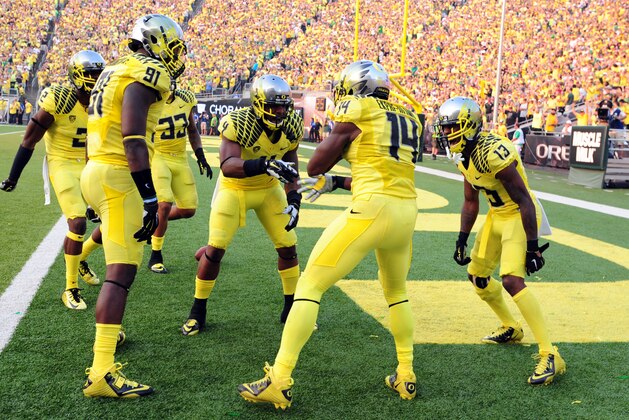 EUGENE, OR -SEPTEMBER 06: Defensive back Ifo Ekpre-Olomu #14 of the Oregon Ducks celebrates  with his teammates after intercepting a pass during the fourth quarter of the game against the Michigan State Spartans at Autzen Stadium on September 6, 2014 in Eugene, Oregon. Oregon won the game 46-27. (Photo by Steve Dykes/Getty Images)