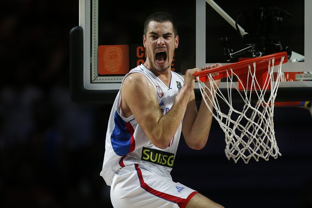 Serbia's Nikola Kalinic shouts after dunking during the World Cup Round of 16 match between Serbia and Greece in Madrid, Spain, Sunday, Sept. 7, 2014 . The 2014 Basketball World Cup competition will take place in various cities in Spain from Aug. 30 through to Sept. 14. (AP Photo/Daniel Ochoa de Olza)