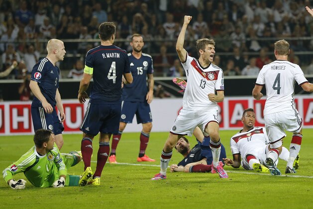 Germany’s Thomas Mueller, center right, celebrates after scoring  during the Euro 2016 soccer qualifying group D match between Germany and Scotland in Dortmund, Germany, Sunday, Sept. 7, 2014. (AP Photo/Frank Augstein)