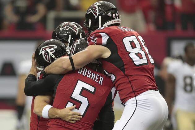 Atlanta Falcons kicker Matt Bryant (3) is mobbed by players after he kicked a field goal against the New Orleans Saints during overtime of an NFL football game, Sunday, Sept. 7, 2014, in Atlanta. The Atlanta Falcons won in overtime 37-34. (AP Photo/John Bazemore)