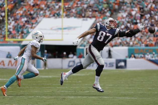 New England Patriots tight end Rob Gronkowski (87) can't catch the ball during the first half of an NFL football game as Miami Dolphins cornerback Brent Grimes (21) runs behind him, in Miami Gardens, Fla., Sunday Sept. 7, 2014. The Dolphins defeated the Patriots 33-20. (AP Photo/Wilfredo Lee) New England Patriots tight end Rob Gronkowski (87) can't catch the ball during the first half of an NFL football game as Miami Dolphins cornerback Brent Grimes (21) runs behind him, in Miami Gardens, Fla., Sunday Sept. 7, 2014. The Dolphins defeated the Patriots 33-20. (AP Photo/Wilfredo Lee)