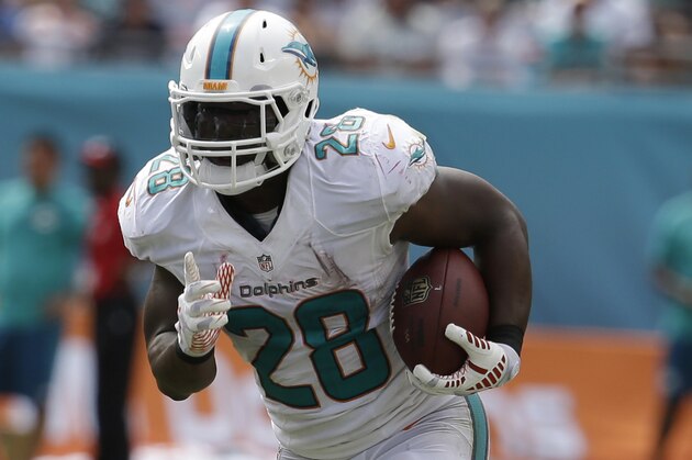 Miami Dolphins running back Knowshon Moreno (28) runs during the second half of an NFL  football game against the New England Patriots, in Miami Gardens, Fla., Sunday Sept. 7, 2014. (AP PhotoLynne Sladky)