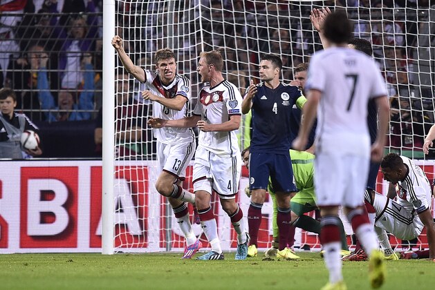 Germany's Thomas Mueller, left, celebrates after scoring his second goal during the Euro 2016 soccer qualifying group D match between Germany and Scotland in Dortmund, Germany, Sunday, Sept. 7, 2014. (AP Photo/Martin Meissner)