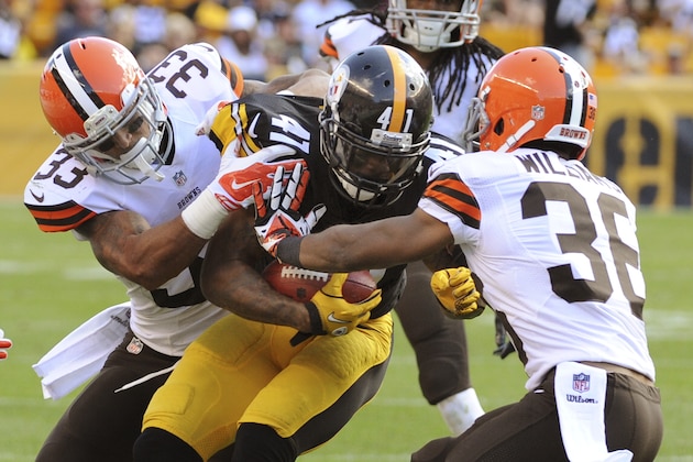 Pittsburgh Steelers' Antwon Blake (41) is tackled by Cleveland Browns cornerback Jordan Poyer (33) and defensive back K'Waun Williams (36) after making a first down on a fake punt attempt in the fourth quarter of the NFL football game on Sunday, Sept. 7, 2014 in Pittsburgh. (AP Photo/Don Wright)