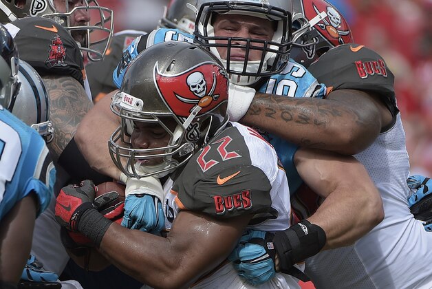 Carolina Panthers middle linebacker Luke Kuechly (59) stops Tampa Bay Buccaneers running back Doug Martin (22) on a run during the first quarter of an NFL football game Sunday, Sept. 7, 2014, in Tampa, Fla. (AP Photo/Phelan M. Ebenhack)