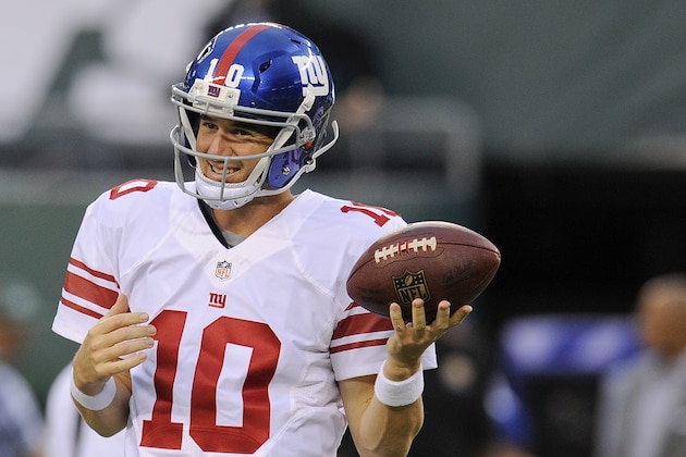 New York Giants quarterback Eli Manning (10) prepares to warm up before playing against the New York Jets in a preseason NFL football game, Friday, Aug. 22, 2014, in East Rutherford, N.J. (AP Photo/Bill Kostroun)
