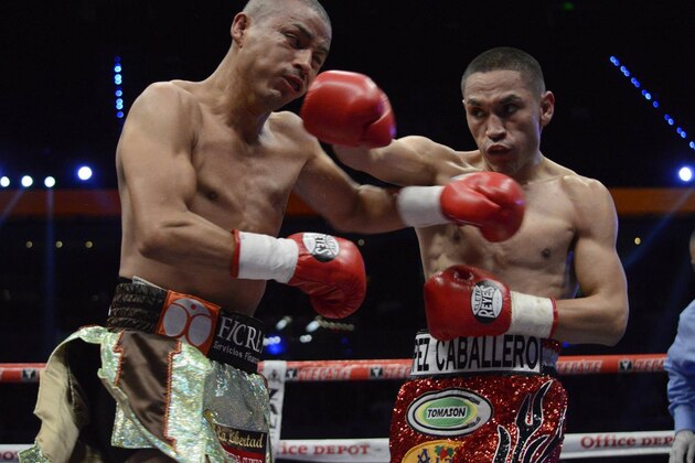 Mexico's Juan Francisco Estrada, right, fights against Milan Melindo of the Philippines during their WBO/WBA Flyweight Title match at the Cotai Arena in Venetian Macao in Macau Saturday July 27, 2013. (AP Photo/Dennis Ho)