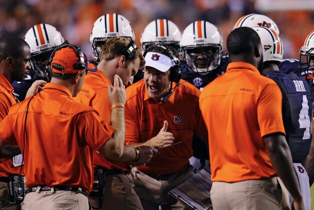 Sep 6, 2014; Auburn, AL, USA; Auburn Tigers head coach Gus Malzahn speaks with his staff and players during a timeout during the first quarter against the San Jose State Spartans at Jordan Hare Stadium. Mandatory Credit: Shanna Lockwood-USA TODAY Sports