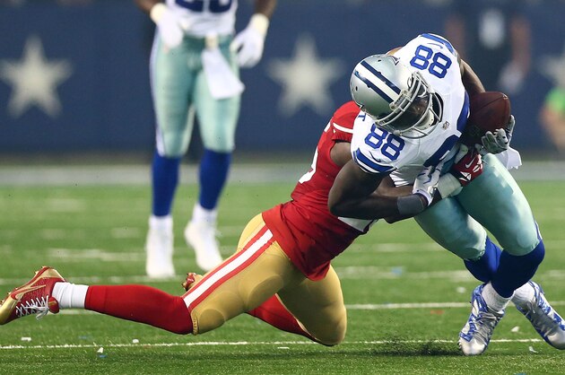 ARLINGTON, TX - SEPTEMBER 07:  Dez Bryant #88 of the Dallas Cowboys is tackled by Tramaine Brock #26 of the San Francisco 49ers in the first half at AT&T Stadium on September 7, 2014 in Arlington, Texas.  (Photo by Ronald Martinez/Getty Images)