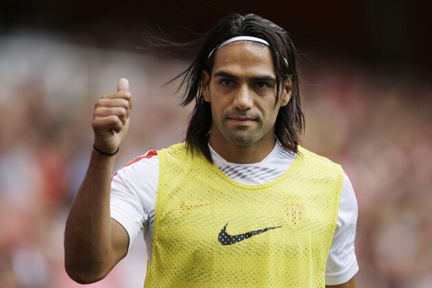 FILE - This is a Saturday, Aug. 2, 2014  file photo of AS Monaco player Radamel Falcao  as he gives a thumbs up to fans as he warms up on the sideline during the second half of the Emirates Cup soccer match between AS Monaco and Valencia at Arsenal's Emirates Stadium in London.  Radamel Falcao is set to join Manchester United on loan after the Premier League club agreed to a loan deal with Monaco, a person with knowledge of the deal said Monday Sept. 1, 2014.  (AP Photo/Matt Dunham, File)
